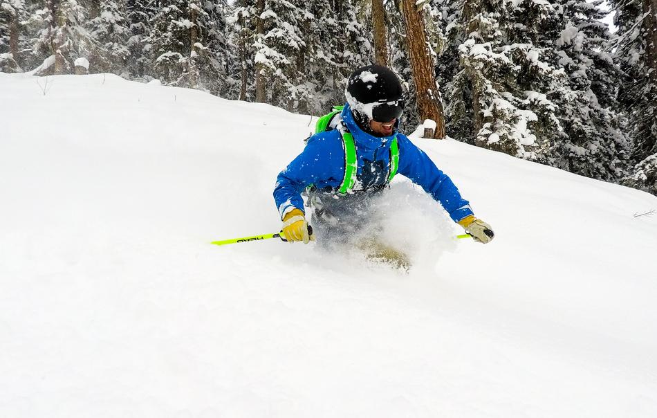 happy man rolls down snow slide