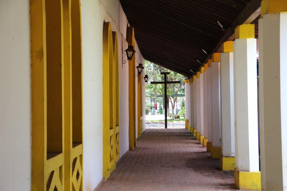 a cross in the distance in the corridor