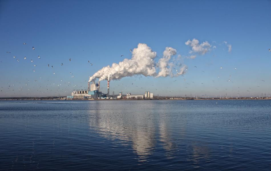 smoke from the pipes of the factory on the island