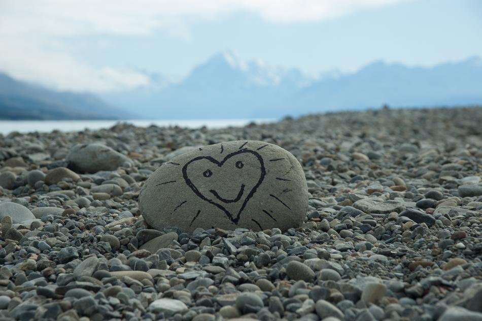 a picture of a heart on a rock on the beach