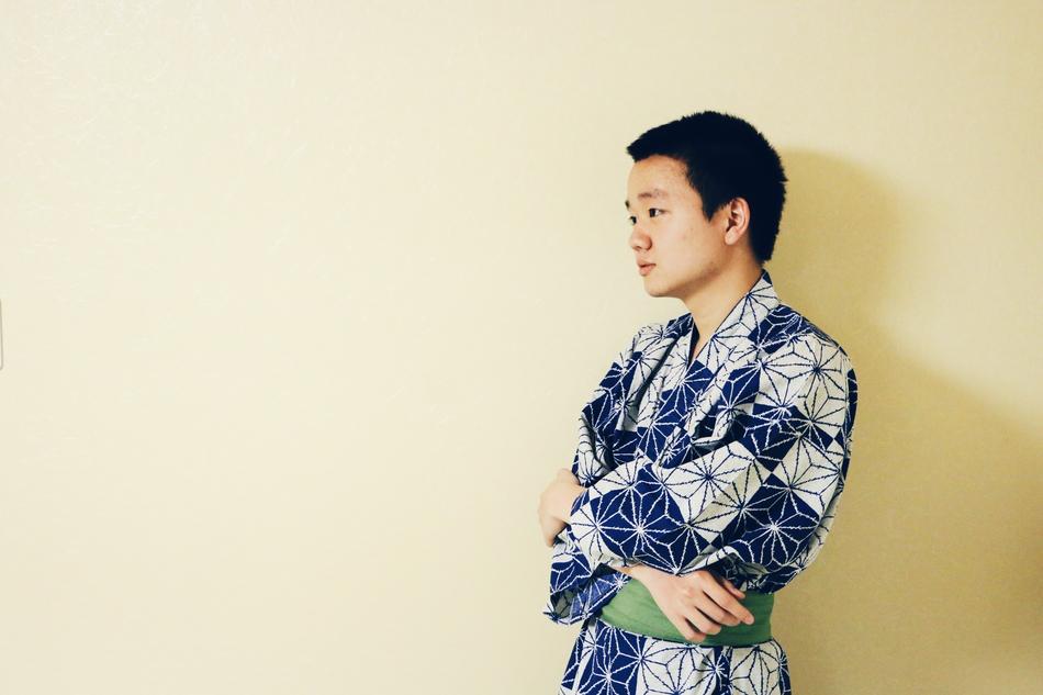 a man in a kimono by the wall