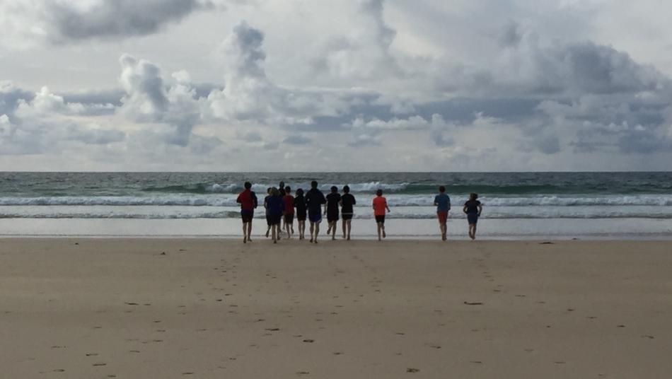 company of people on the beach by the sea