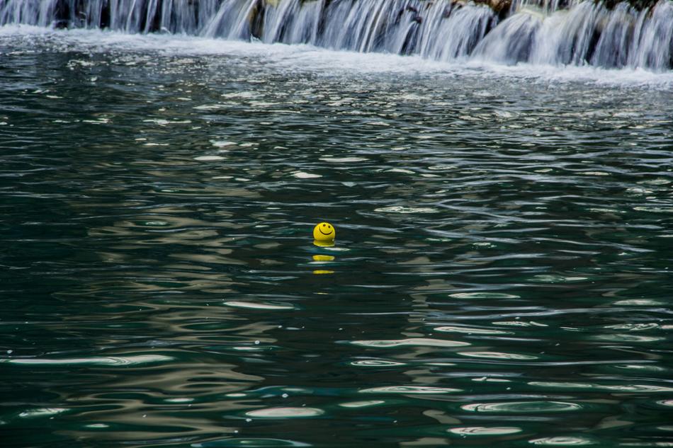 smiley face in green water