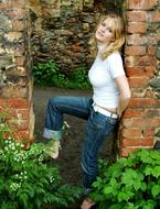 young girl standing in Passage In Bricks Wall