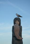 seagull on an old sculpture