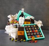 chocolates in a box with a wine bottle