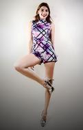 pretty girl in short dress posing at blur background
