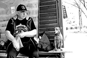monochrome photo of friendship between man and dog