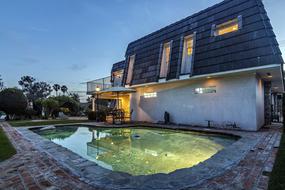 pool with light near the house