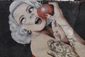 Graffiti girl with a tattoo on the wall
