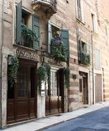 Beautiful osteria restaurant entrance with decorations on the street of Verona in Italy