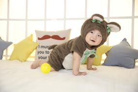 a cute kid in a costume with a bottle.
