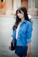 portrait of Beautiful Girl in jeans jacket in city