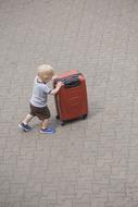 Child and red suitcase figure
