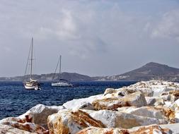 floating yachts on the sea overlooking the beach