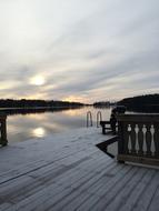 wooden bridge overlooking the sun