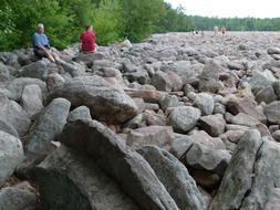 people walking by the rocks