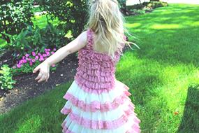 blonde in a pink dress in the garden