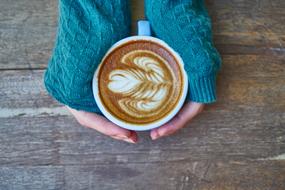 delicious milk coffee in hand