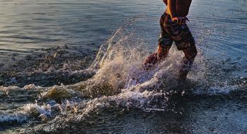 child boy running through water, detail