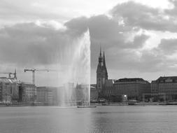 a fountain in a lake near the city