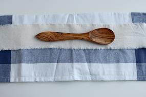 wooden spoon on a colored table