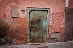 Old metal Door in grunge red Wall