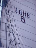 Close-up of the wavy, white and blue sail, of the ship, on the Elbe River, in Hamburg, Germany