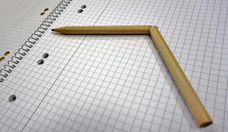 a wooden pencil broken on paper