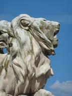 white stone lion against the sky