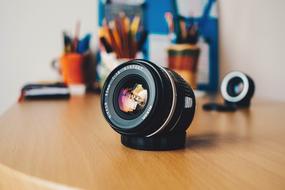 Camera lens on the wooden table