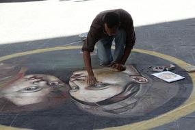 man wipes down a painting