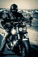 black and white photo of a motorcyclist in a helmet