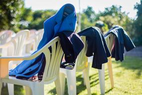 coats and jackets on chairs in the park