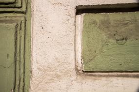 Green wood texture on the old, white wall