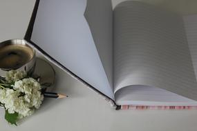 white notebook with cup