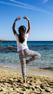 girl in ballerina pose by the sea