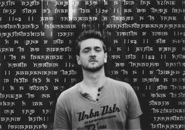 photo of a young man against a background of religious antique scripture