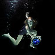 Underwater shot of a girl with a watch in her hand