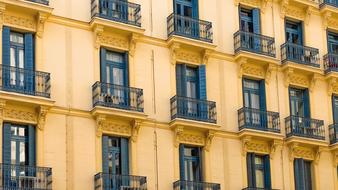 yellow facade with black railings on balconies, Spain, Madrid