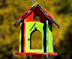 colorful bird feeder on blurred background