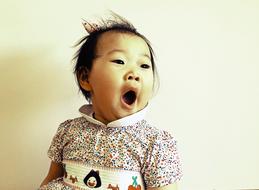 funny asian Child girl with wide open mouth