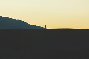 human silhouette at minimalist Mountain landscape