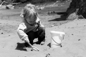 a small child on the beach by the sea playing