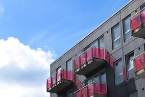 pink balconies on grey contemporary facade