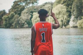 Back View of dark skin young Boy on riverside