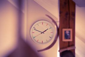 wall clock in pink blurred background