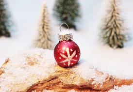 red christmas ball on the background of winter decoration