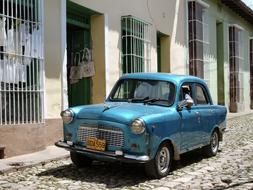 blue car in front of the houses