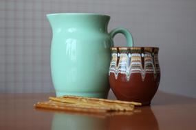 a teapot with a jug on the table